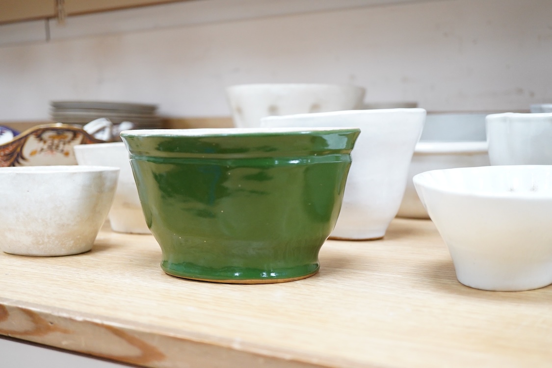 A collection of fifteen mostly 20th century ceramic jelly moulds, largest 16cm high